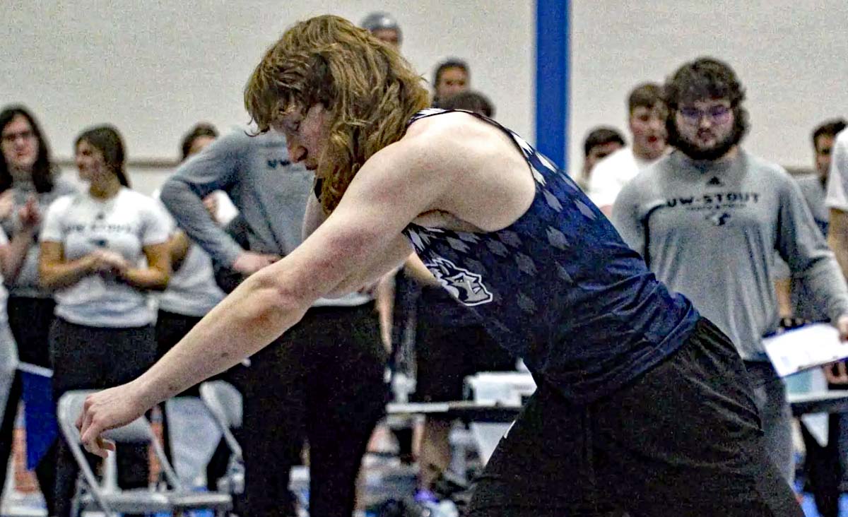 A UW-stout member of the men's track and field team gets ready to throw the indoor shot put.