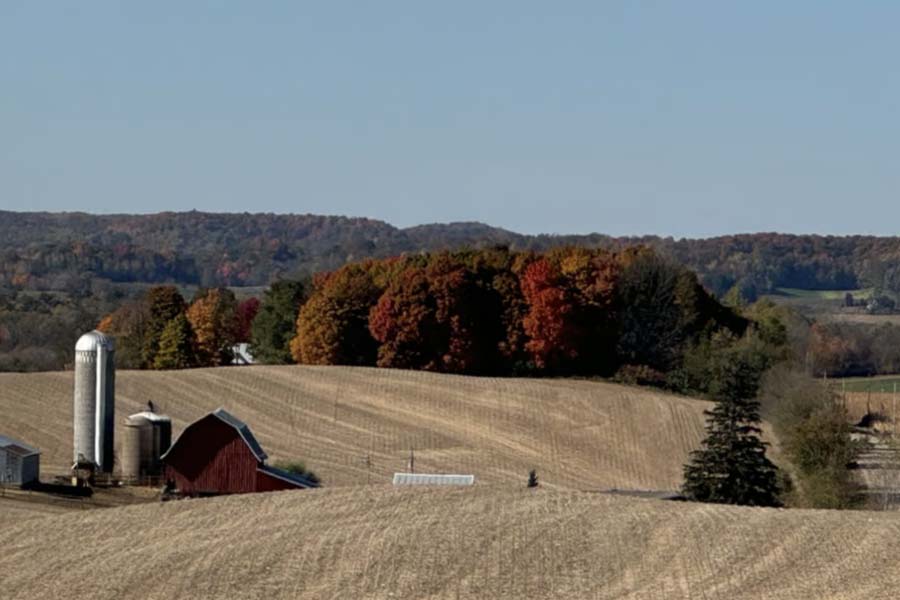 Rolling hills and two farms west of Menomonie in the fall.