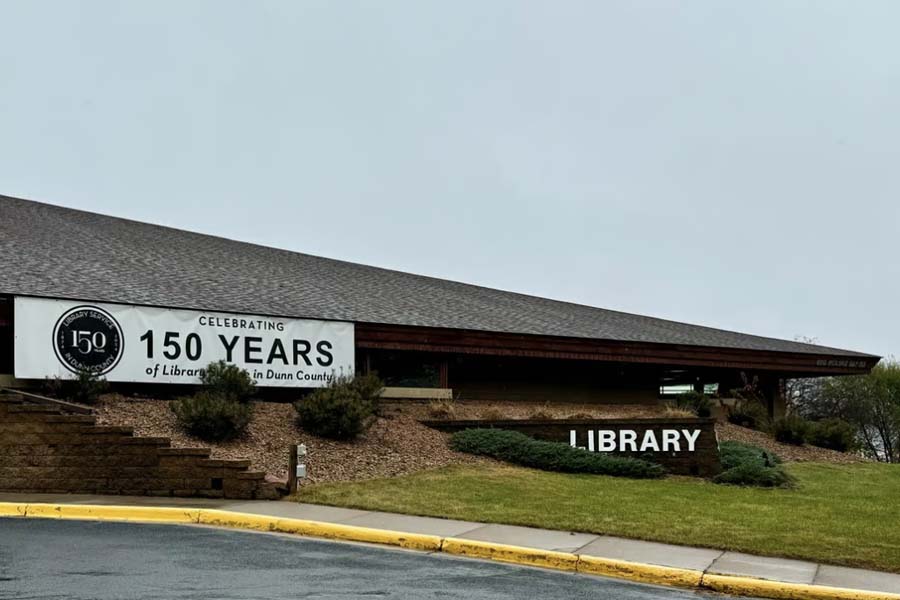 The Menomonie Public Libary with a sign that reads 150 years of libaries in Dunn County.