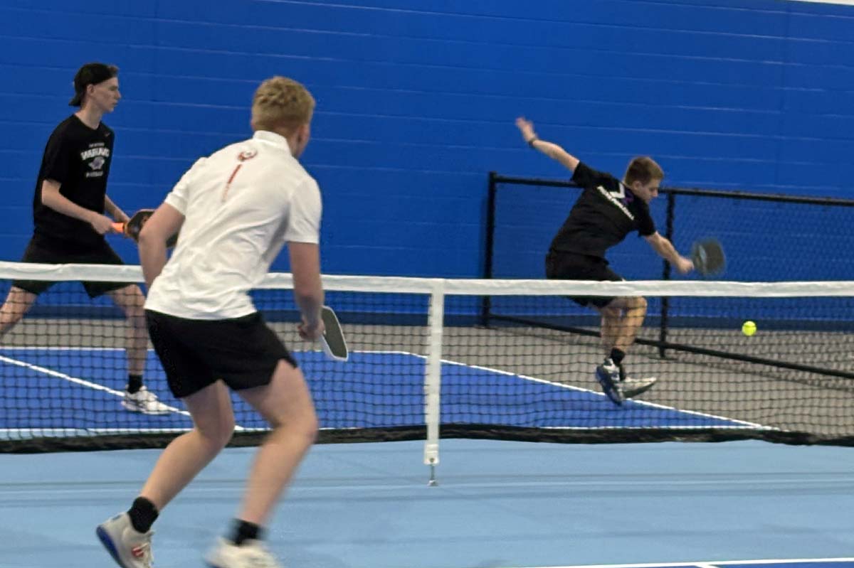 three men playing pickleball