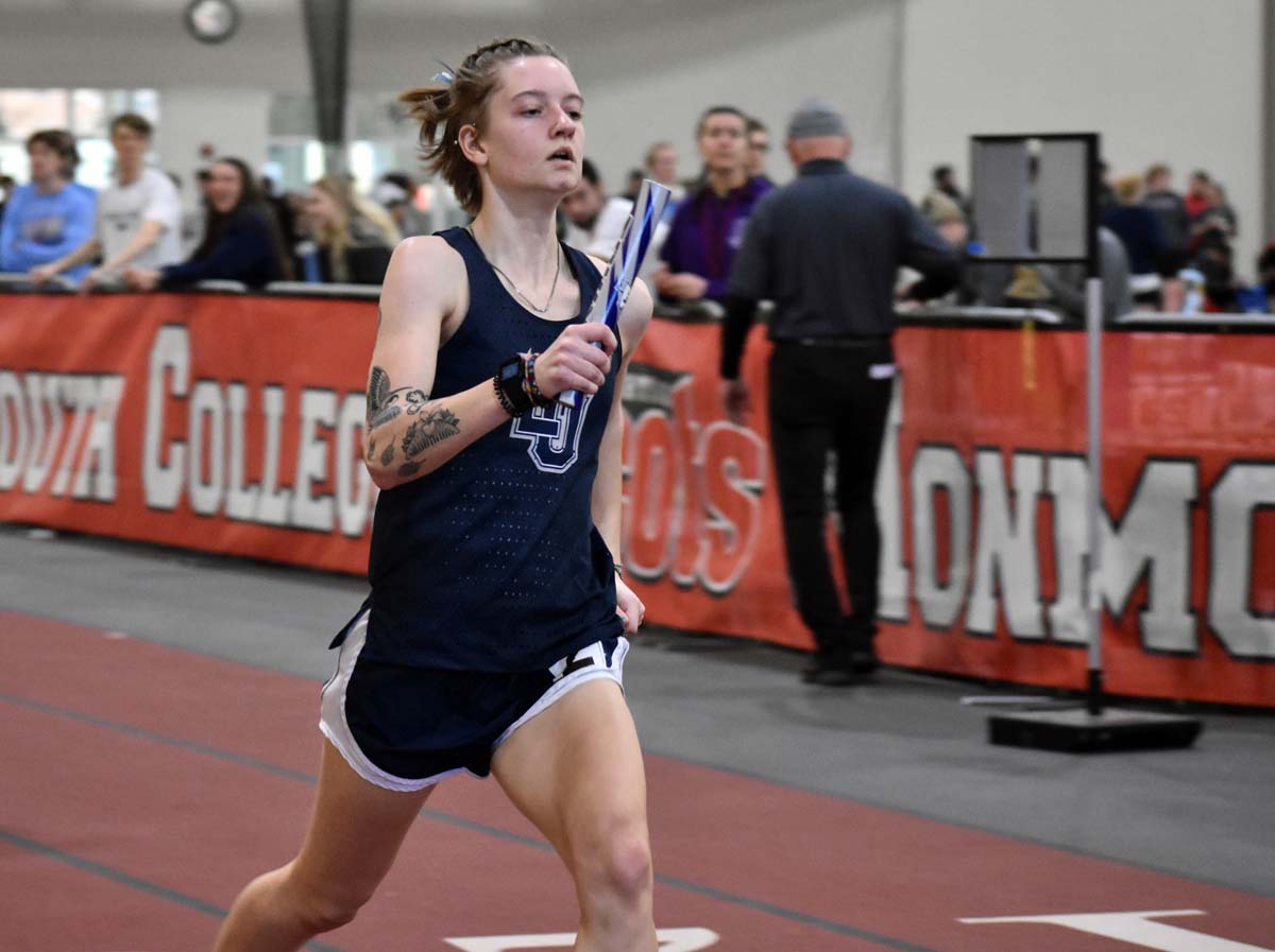 Lawrence University's Gaby Skorczewski runs with the baton in a relay race.