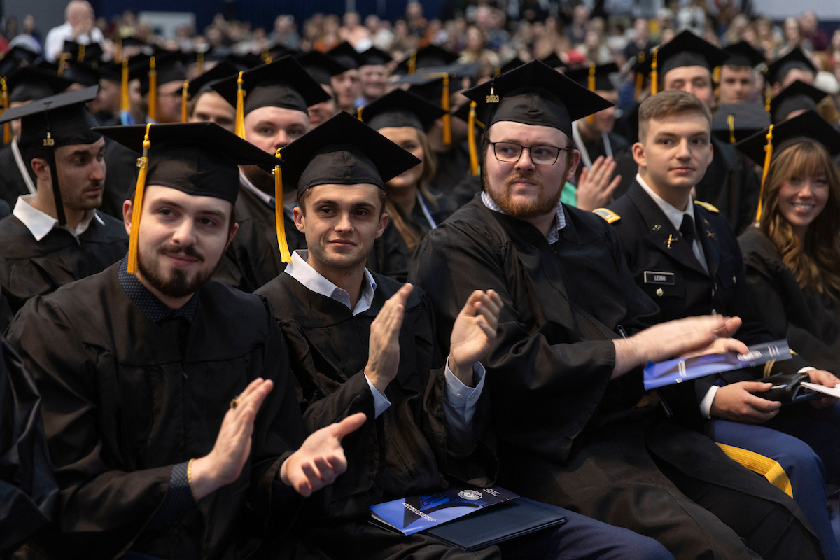 Students receive their diplomas during Fall 2023 graduation.
