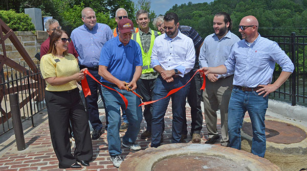 Menomonie Mayor Randy Knaack cuts a ribbon dedicating the Tainter Gate  Historical Overlook in a ceremony held on Thursday, June 19.