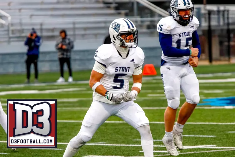 A UW-Stout football player, dressed in white uniform, reacts to a play.