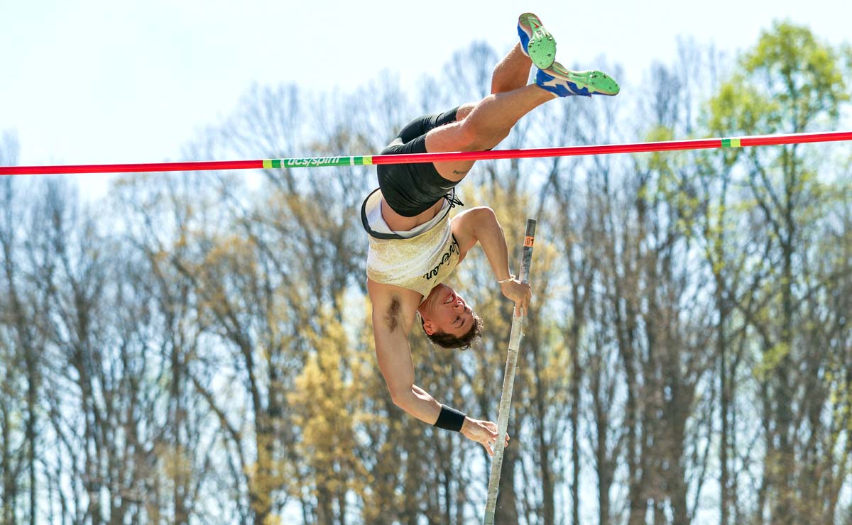 A student-athlete clears the pole vault bar at a recent meet.