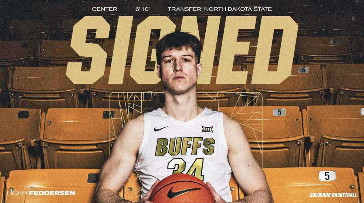 A male basketball player sits in the stands while holding a basketball.