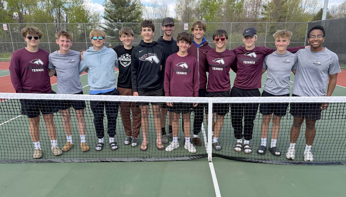 The Menomonie boys tennis team lines up behind the net.