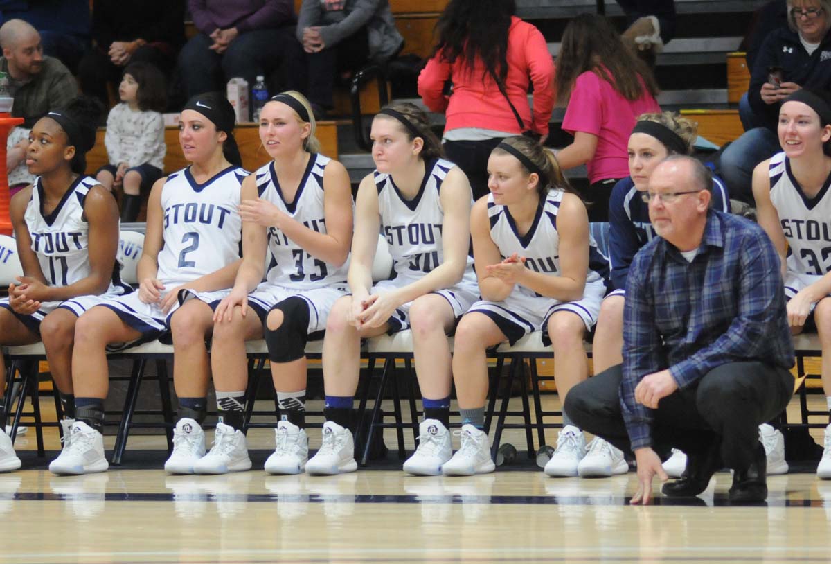 UW-Stout women's basketball coach Mark Thomas in front of his bench.