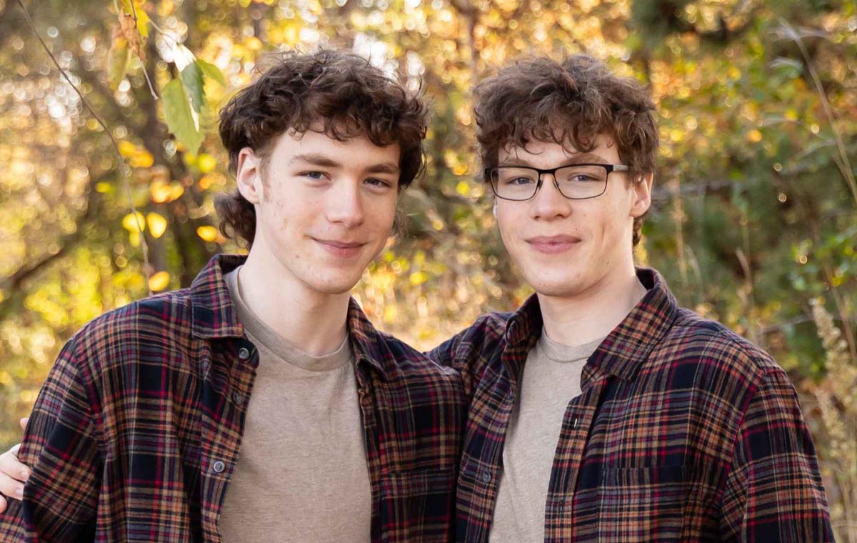 photo of two brothers in a fall woodland setting.
