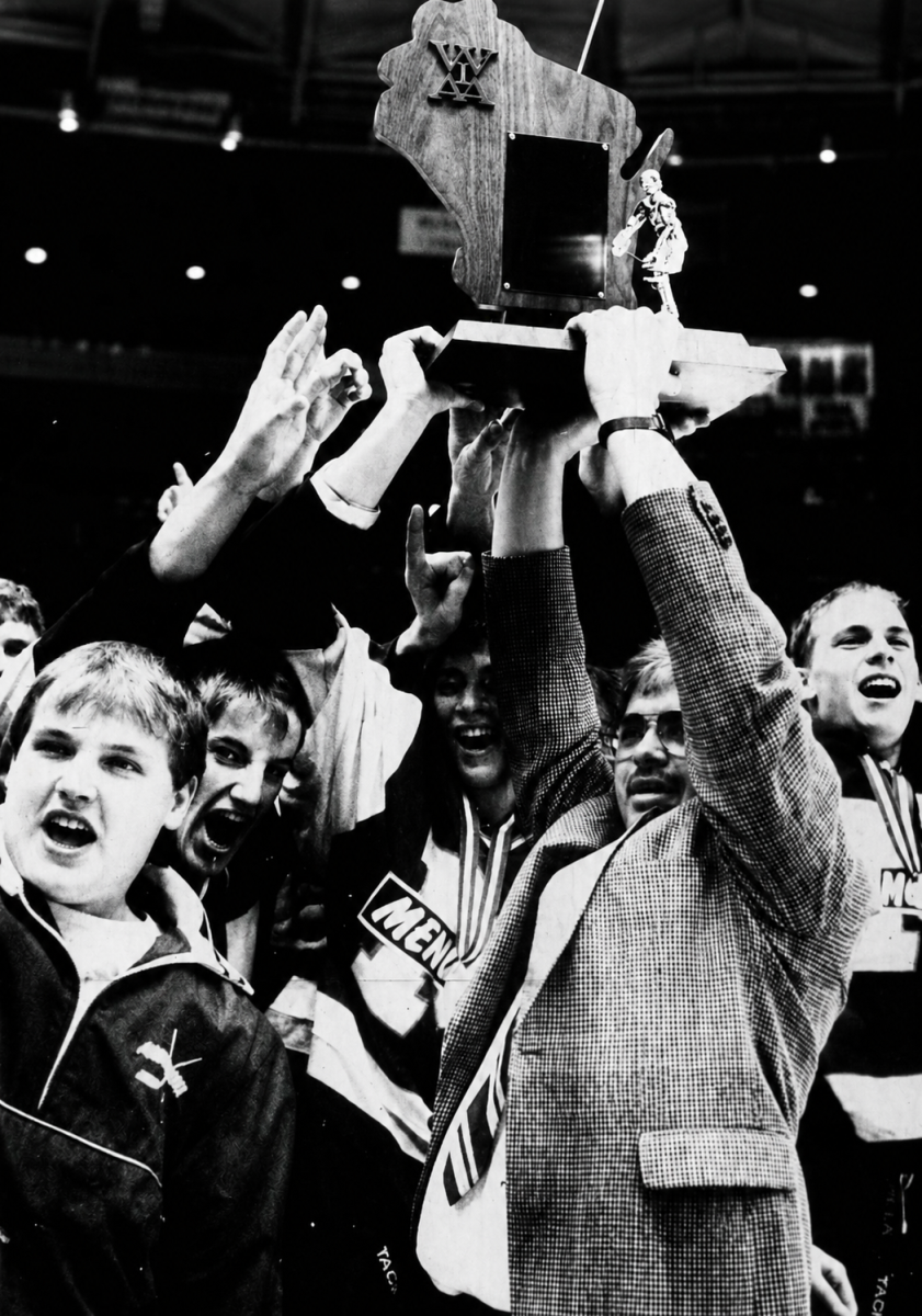 The 1991 Wisconsin Division 1 Hockey state championship trophy is hoisted the by head coach.