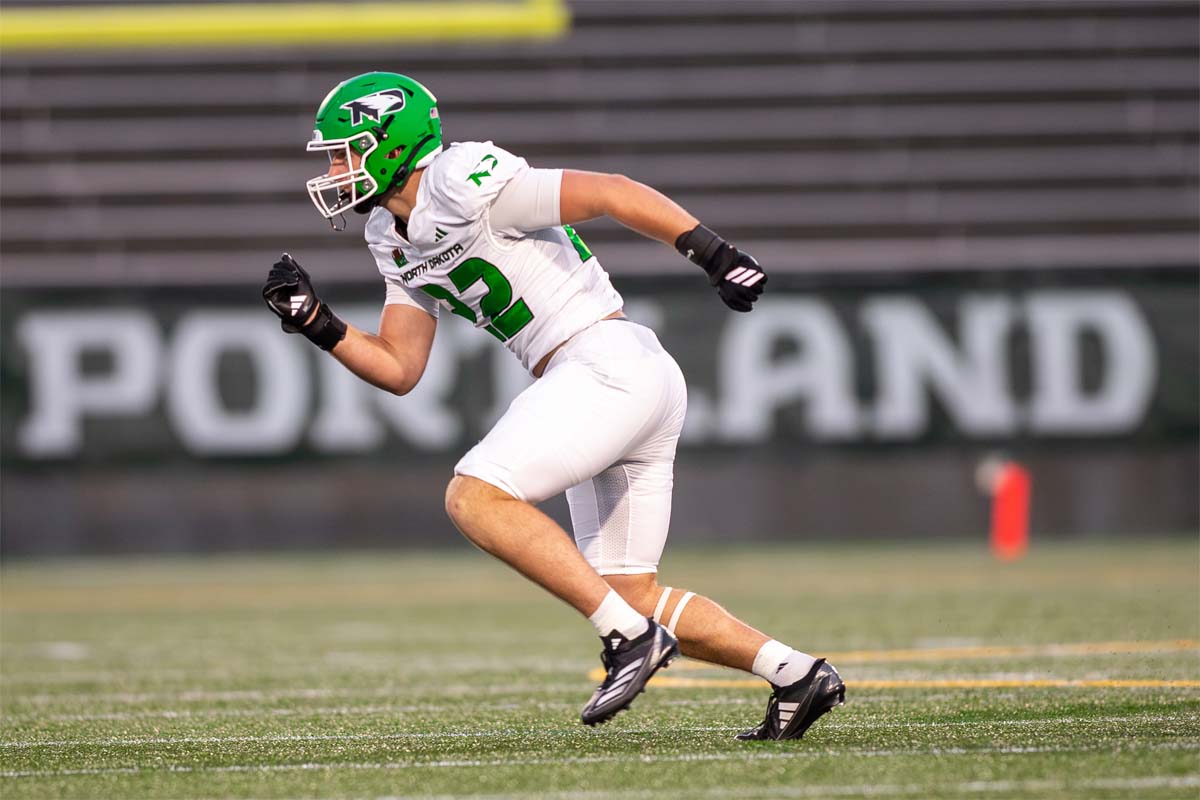 A football players runs down the field.